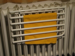 Sušák D550 na litinovém radiátoru lze sklopit do prostorově úsporné polohy i s prádlem